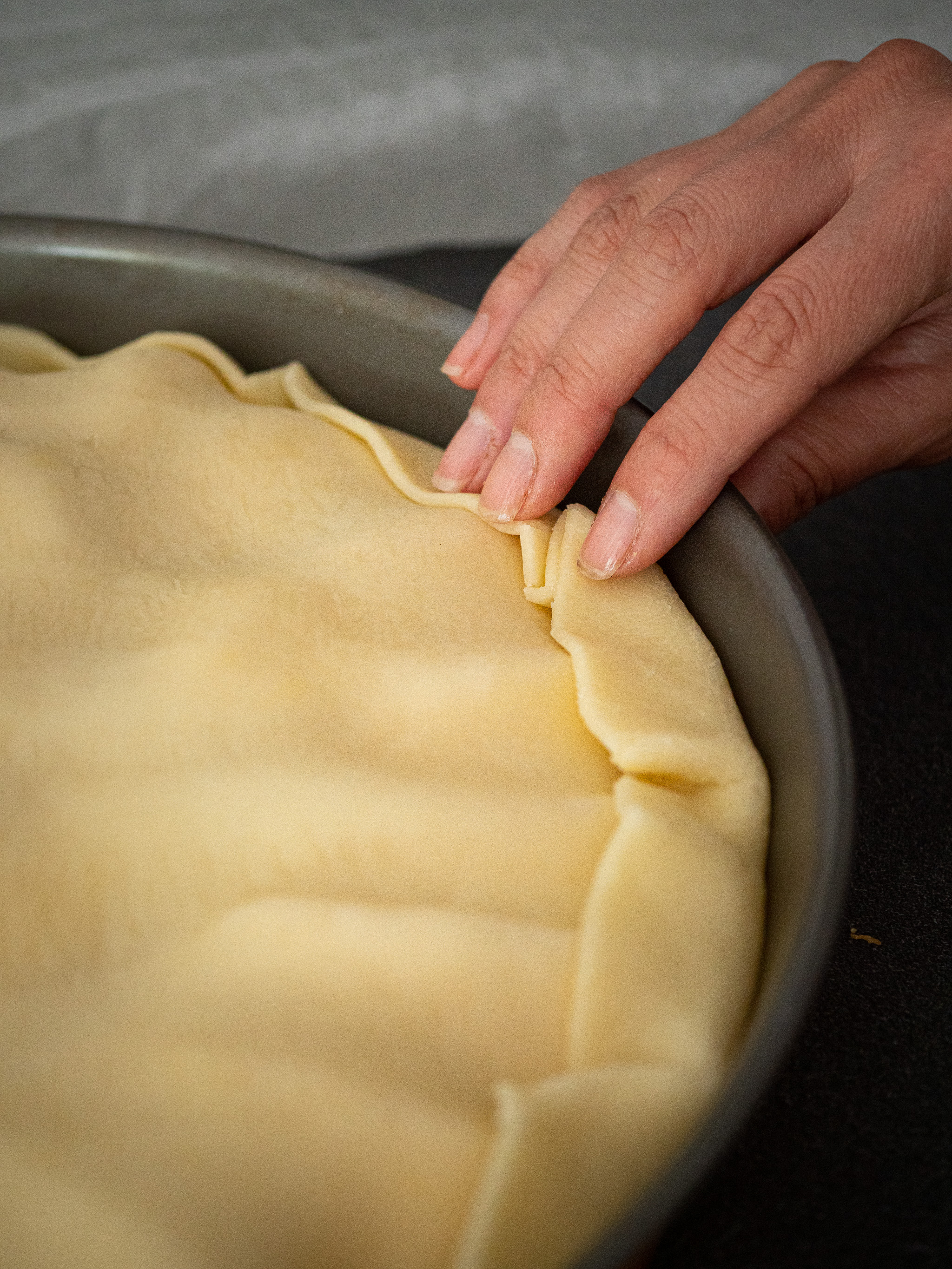 Coincer la pâte entre le bord et les pommes et rabattre l'excédent